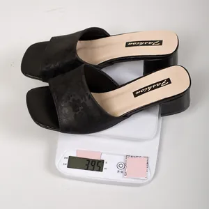 Black floral pattern chunky heel slide sandals on a digital scale showing a weight of 395g.