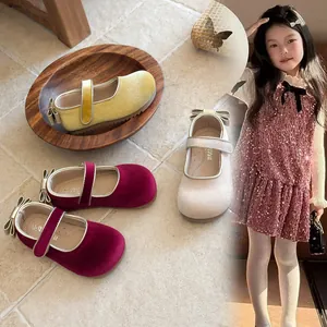 Detail view of elegant velvet Mary Jane shoes for girls with bow accents and soft soles