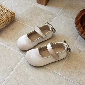 Close-up detail of elegant beige velvet Mary Jane shoes for girls with back bow accent
