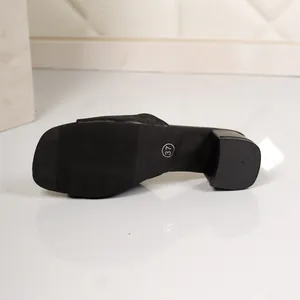 Detailed bottom view of a black chunky heel sandal showing non-slip sole and size