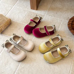 Detailed view of velvet girls Mary Jane shoes with bow accents available in three colors