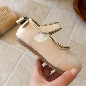 Detailed side view of beige velvet girls' Mary Jane shoe with bow and rubber sole