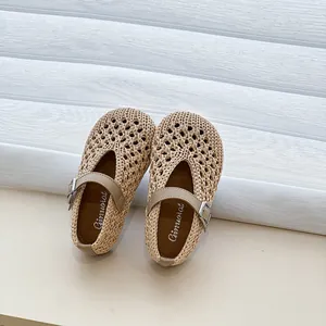 Detailed close-up of beige woven girls' Mary Jane sandals featuring a hollow-out design.