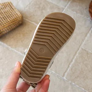 Detailed macro view of the non-slip brown rubber sole for girls velvet shoes in size 23