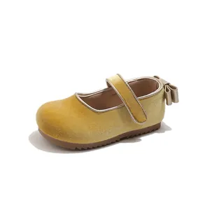 Detailed view of yellow velvet girls' Mary Jane princess shoe with heel bow and strap
