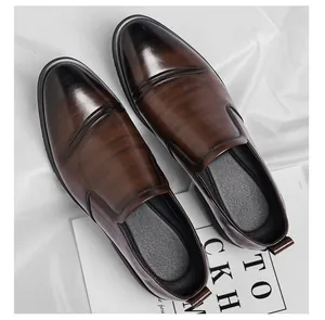 Macro detail of the smooth brown leather texture on these classic men's dress loafers.