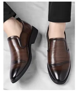 Close-up of men's brown formal leather slip-on shoes with elegant textured finish