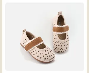 Close-up of girls' breathable hollow-out leather shoes with soft soles and brown lace straps
