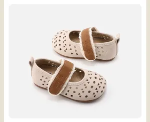 Detailed top-down view of beige toddler girls' hollow shoes with a decorative brown strap