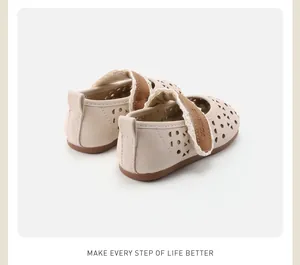 Macro view of cream toddler girls leather shoes showing breathable laser cut hollow pattern