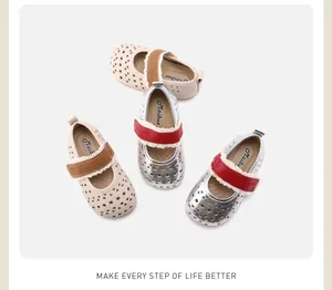 Detailed view of children's hollow leather shoes in beige and silver colors.