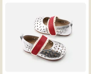 Close-up of girls' silver metallic Mary Jane shoes with red lace velcro straps