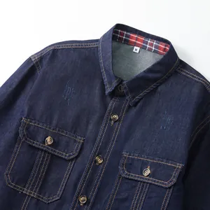 Close-up of men's dark blue denim shirt featuring chest pockets and contrast stitching