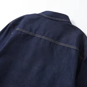 Close-up back detail of a navy blue denim work shirt showing fine stitching and fabric