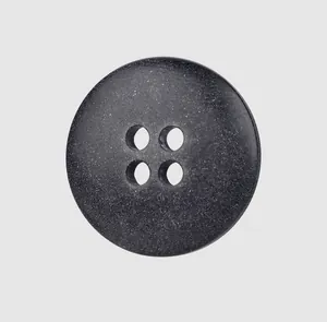 Macro detail of high-end dark grey four-hole resin button for premium clothing