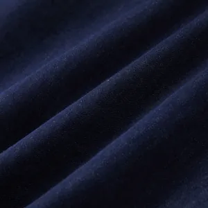 Detailed macro view showing the fine weave and dark navy texture of denim shirt fabric