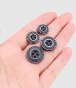 Detailed macro view of high-quality dark grey resin buttons in four different sizes