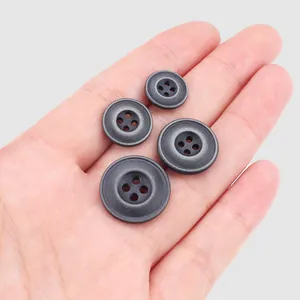 Premium dark grey resin four-hole buttons in various sizes shown held in a hand