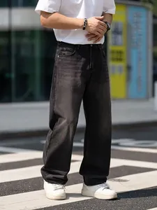 Men's loose straight-leg washed vintage black jeans shown in a natural outdoor street setting