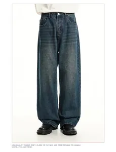 Detail shot of men's loose straight-leg retro blue washed denim jeans for summer.
