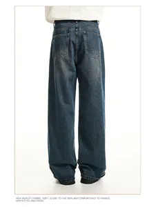 Detail of the back of men's loose straight-leg vintage washed denim jeans.