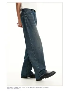 Side view detail of men's vintage washed blue denim jeans with a relaxed wide-leg fit