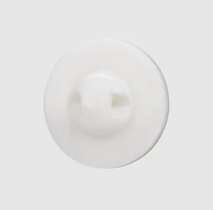 Detailed macro view of a high-end white mother of pearl shell button for luxury clothing.