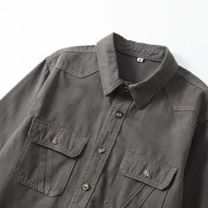 Close-up of men's charcoal cotton shirt featuring double chest pockets and contrast stitching