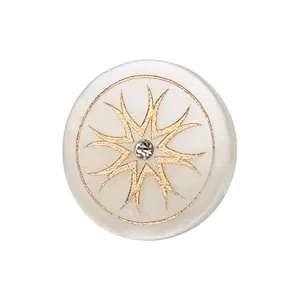 High-end white mother-of-pearl button with gold starburst pattern and central crystal