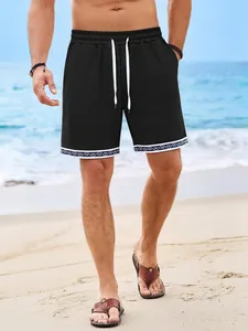 Pantaloncini da spiaggia neri in tessuto waffle da uomo con bordo geometrico e coulisse