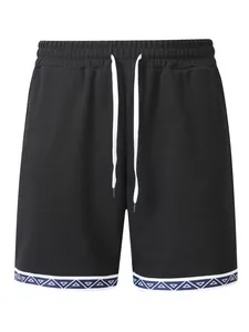 Dettaglio dei pantaloncini in maglia waffle neri con bordo geometrico e coulisse in vita
