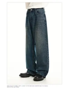 Detail view of men's vintage washed wide-leg denim jeans in blue finish