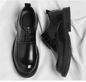 Top and side view of black leather men's business dress shoes on white fabric.