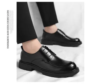 Detailed view of polished black leather men's dress shoes with lace-up closure