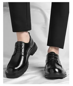 Close-up of black leather lace-up business formal shoes for men, worn with black pants