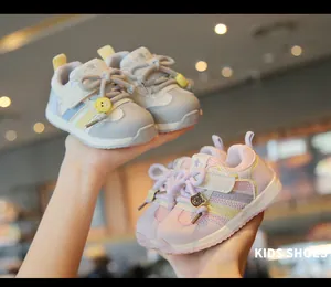 Close-up of pink and grey toddler sneakers with breathable mesh and cute bear charms