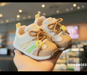 Close-up of children walking sneakers with breathable mesh and cute yellow bear decor