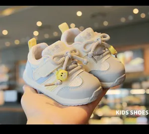 Close-up of breathable mesh baby sneakers with cute bear charm and soft sole