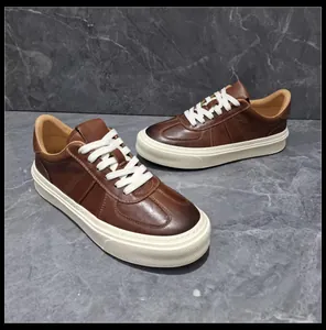Close-up detail of premium brown leather sneakers featuring thick white rubber soles