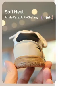 Close-up detail showing the soft and cushioned heel of white toddler walking shoes