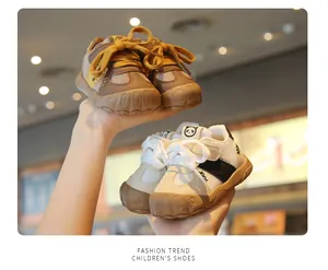 Detailed view of breathable mesh toddler walking shoes with soft non-slip soles.