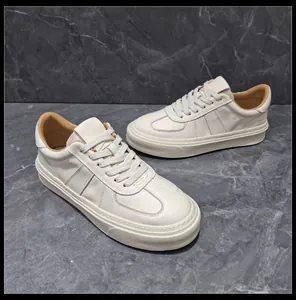 Detailed view of men's retro white leather sneakers with thick soles and lace-up design