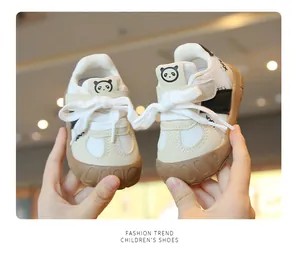 Close-up of breathable mesh toddler walking shoes with cute panda design on tongue.