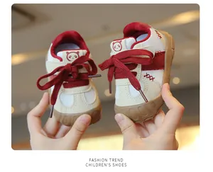 Close-up of breathable mesh infant walking shoes with soft soles in red and beige