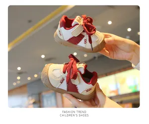 Close-up of red and white breathable baby walking shoes with anti-slip soft soles for toddlers