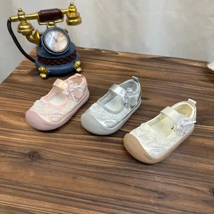 Detail of breathable girls' mesh sandals with bow accents in pink silver and cream
