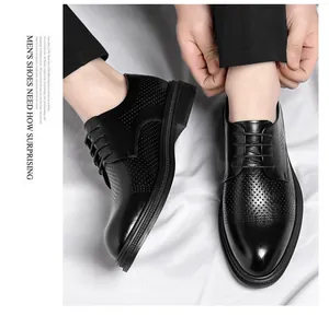 Detailed view of men's black perforated leather business dress shoes with lace-up design