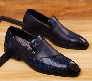 Gedetailleerd overzicht van herenloafers met blauw reliëf krokodillenleer