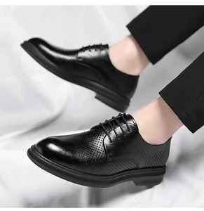 Side view detail of men's black hollow-out business dress shoes with elevator soles