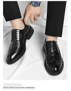 Close-up detail of men's black crocodile pattern brogue shoes with classic wingtip design
